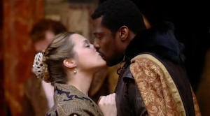 Eamonn Walker as Othello and Zoe Tapper as Desdemona kiss
